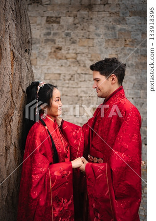 Interracial couple celebrating traditional Chinese wedding ceremony 133918396