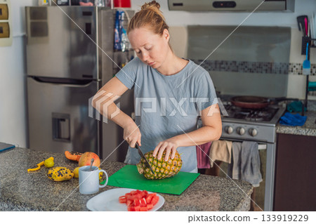 Woman preparing breakfast in a bright home kitchen, enjoying a calm morning routine and creating a warm start to the day. Healthy lifestyle, home cooking and cozy domestic living concept showing Woman preparing breakfast in a bright home kitchen, enjoying a calm morning routine and creating a warm start to the day. Healthy lifestyle, home cooking and cozy domestic living concept showing 133919229