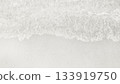 Waves collide on a sandy beach showing water patterns and textures during daytime 133919750