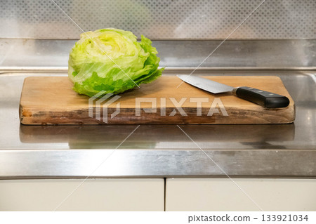 Lettuce and knife on a cutting board 133921034