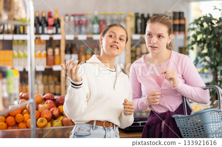 Women choose products in the supermarket 133921616