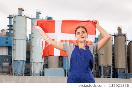 Concentrated young woman holds the national flag of Denmark Concentrated young woman holds the national flag of Denmark 133921826