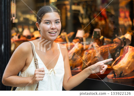 Young girl chooses delicacy - exquisite dry-aged beef on restaurant display 133922126