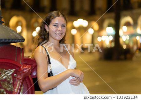 woman stands near a pole in the Plaza de Barcelona 133922134