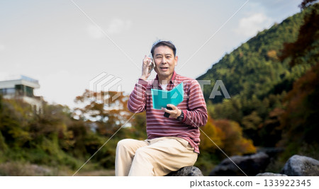 一名男子在河岸邊放鬆休息。 一名男子在河岸邊放鬆休息。 133922345