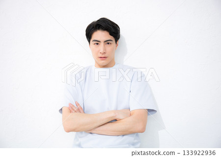 A refreshing man in short sleeves on a white background, looking at the camera 133922936