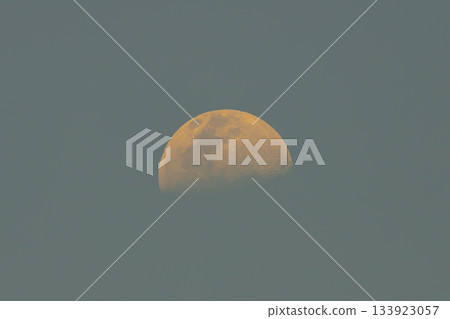An orange moon during the rising phase in mid afternoon An orange moon during the rising phase in mid afternoon 133923057