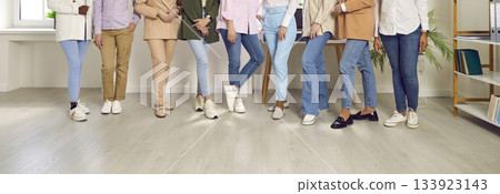 Legs of unrecognizable business people women standing in a row at the office. 133923143