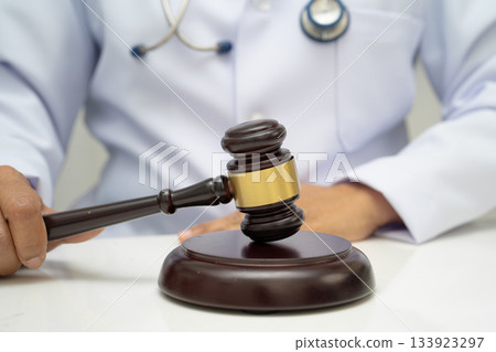 Doctor holding judge gavel, forensic medicine, medical law and crime justice. 133923297
