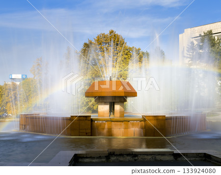 A park fountain and rainbow on a clear autumn day - Almaty, Kazakhstan A park fountain and rainbow on a clear autumn day - Almaty, Kazakhstan 133924080