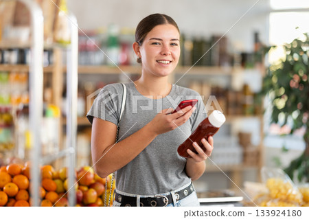 Young woman scanning qr code for ketchup 133924180