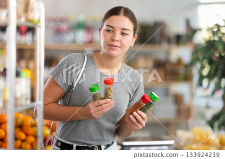 Woman chooses spices and seasonings 133924239