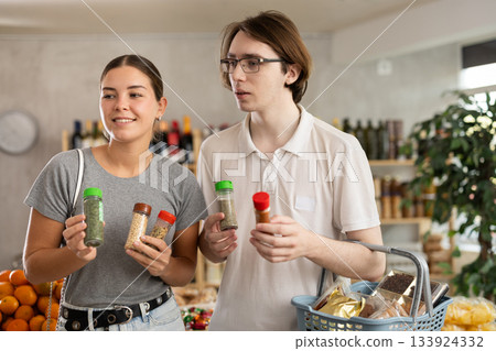 Couple young man and woman choosing spices and seasonings 133924332