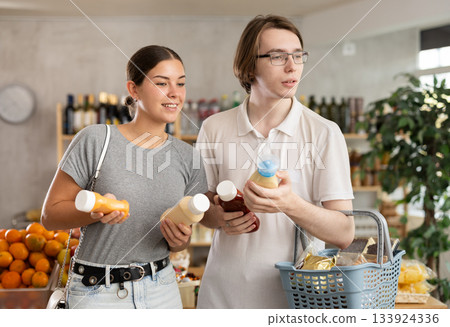 Married couple choosing sauces Married couple choosing sauces 133924336