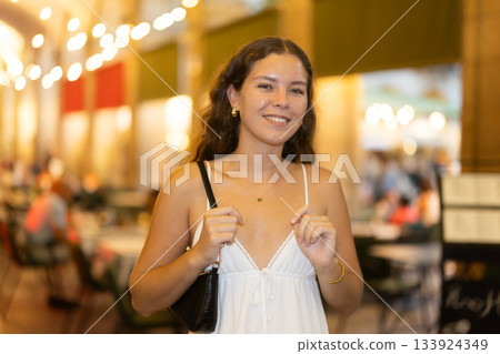 In night, young smiling girl walks along city street Ferran In night, young smiling girl walks along city street Ferran 133924349