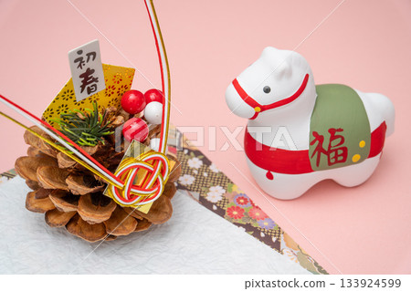 A photo composition of early spring decorations and a white horse figurine 133924599