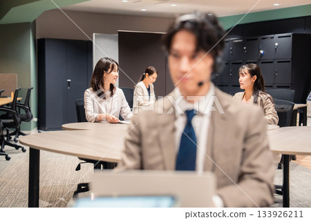 Women working and talking happily in the office Women working and talking happily in the office 133926211