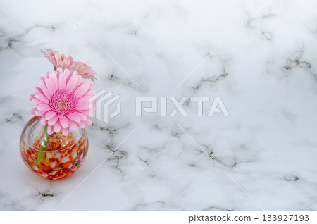 Two pink gerbera flowers in a warm glass vase (bottom left) Two pink gerbera flowers in a warm glass vase (bottom left) 133927193