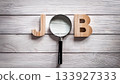 Magnifying Glass Searching for Job Concept on Wooden Surface with Wooden Letters J and B 133927333