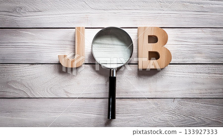 Magnifying Glass Searching for Job Concept on Wooden Surface with Wooden Letters J and B 133927333