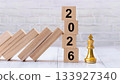 2026 Wooden Blocks Next to Gold King Chess Piece Symbolizing Leadership and Strategic Planning 133927340