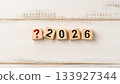 Red Question Mark Icon with Wooden Blocks Spelling 2026 Representing Uncertainty or Planning the Future 133927344