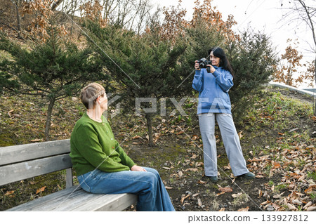 Two Russian women in their 50 years old and 60 years old enjoy an outdoor photo session, showing creativity, mindfulness, active aging and a calm supportive friendship. Two Russian women in their 50 years old and 60 years old enjoy an outdoor photo session, showing creativity, mindfulness, active aging and a calm supportive friendship. 133927812