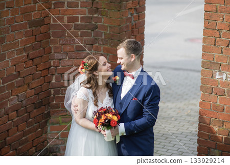 Smiling Bride and Groom Facing Each Other Outdoors Smiling Bride and Groom Facing Each Other Outdoors 133929214