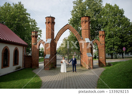 Romantic wedding couple under historic brick arches Romantic wedding couple under historic brick arches 133929215