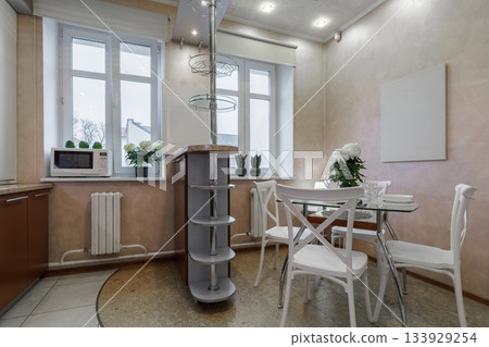 Bright Kitchen Interior with Dining Table and Large Windows Bright Kitchen Interior with Dining Table and Large Windows 133929254