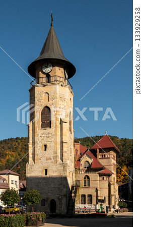 Medieval stone clock tower stands tall under clear Piatra Neamt sky Medieval stone clock tower stands tall under clear Piatra Neamt sky 133929258