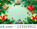 A card with Christmas tree branches, colorful ornaments, many colorful gift boxes setting around the light green copy space background. 133929912