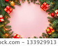 A card with Christmas tree branches, gift boxes, ornaments in flat lay composition and light pink copy space. 133929913