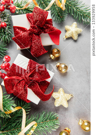 Christmas presents with festive decorations on gray background Christmas presents with festive decorations on gray background 133929958