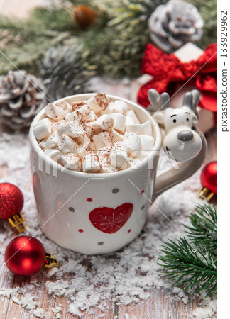 Reindeer mug holding hot chocolate with marshmallows in snow 133929962