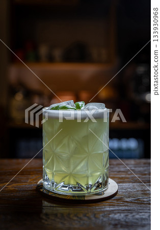 Basil cocktail on wooden bar 133930968