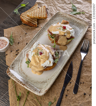 Eggs benedict with poached eggs 133930997