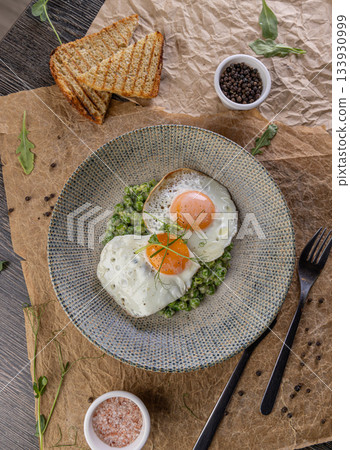Fried eggs with green peas Fried eggs with green peas 133930999