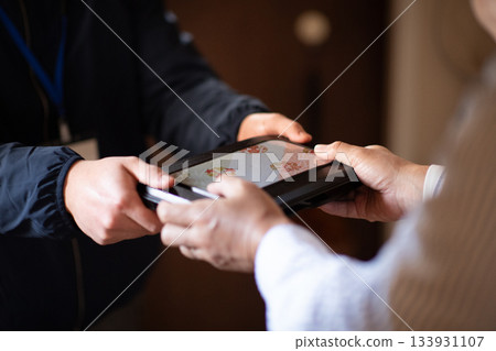 An elderly man receiving a home-delivered lunch box An elderly man receiving a home-delivered lunch box 133931107