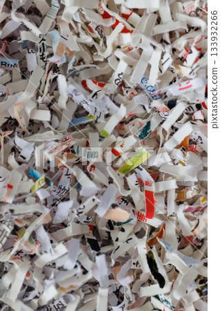 Paper cut into small pieces by a shredder 133932266