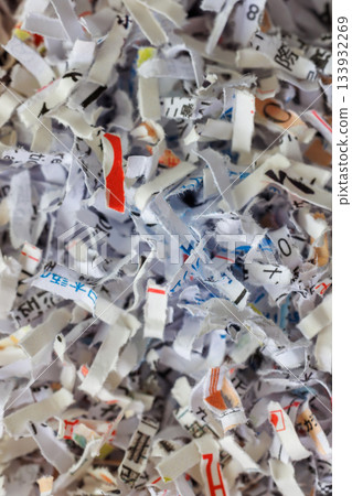 Paper cut into small pieces by a shredder 133932269