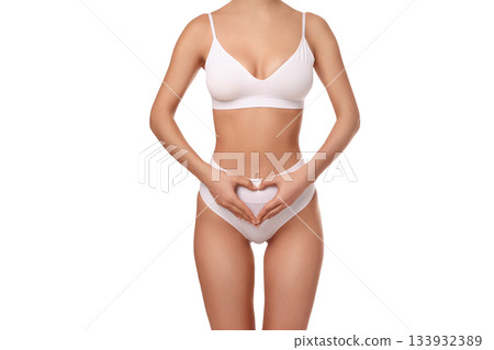 Woman poses with hands in heart shape on stomach, isolated on white, PNG Woman poses with hands in heart shape on stomach, isolated on white, PNG 133932389