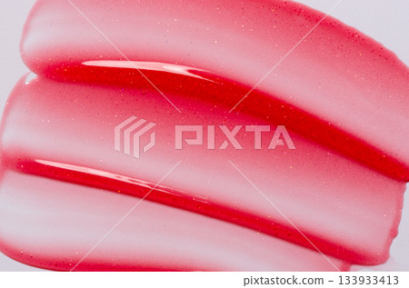 Lip oil, liquid red lipstick. Cosmetic product for lip moisturizing. 133933413