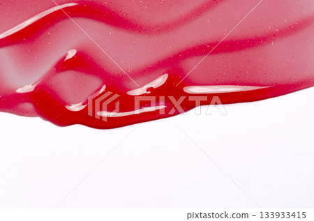 Lip oil, liquid red lipstick. Cosmetic product for lip moisturizing. Copy space 133933415