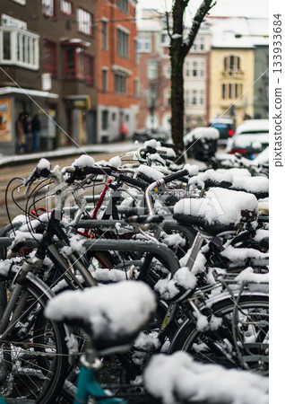 Black bicycle under the snow outside after a snowfall in town. Black bicycle under the snow outside after a snowfall in town. 133933684