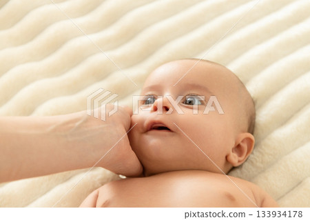 Joyful interaction between a mother and her newborn baby Joyful interaction between a mother and her newborn baby 133934178