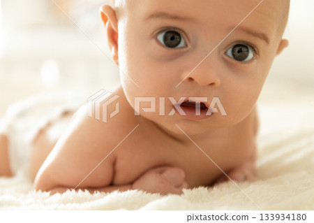 Curious baby enjoying time on the cozy blanket at home Curious baby enjoying time on the cozy blanket at home 133934180