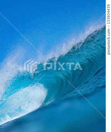 Majestic ocean swell with shimmering sunlight and foamy crest Majestic ocean swell with shimmering sunlight and foamy crest 133934439