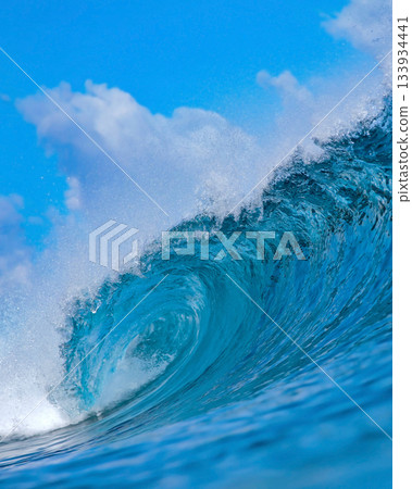 Majestic ocean swell with shimmering sunlight and foamy crest Majestic ocean swell with shimmering sunlight and foamy crest 133934441