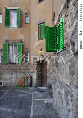 charming italian village alley with green shutters and stone walls charming italian village alley with green shutters and stone walls 133934555
